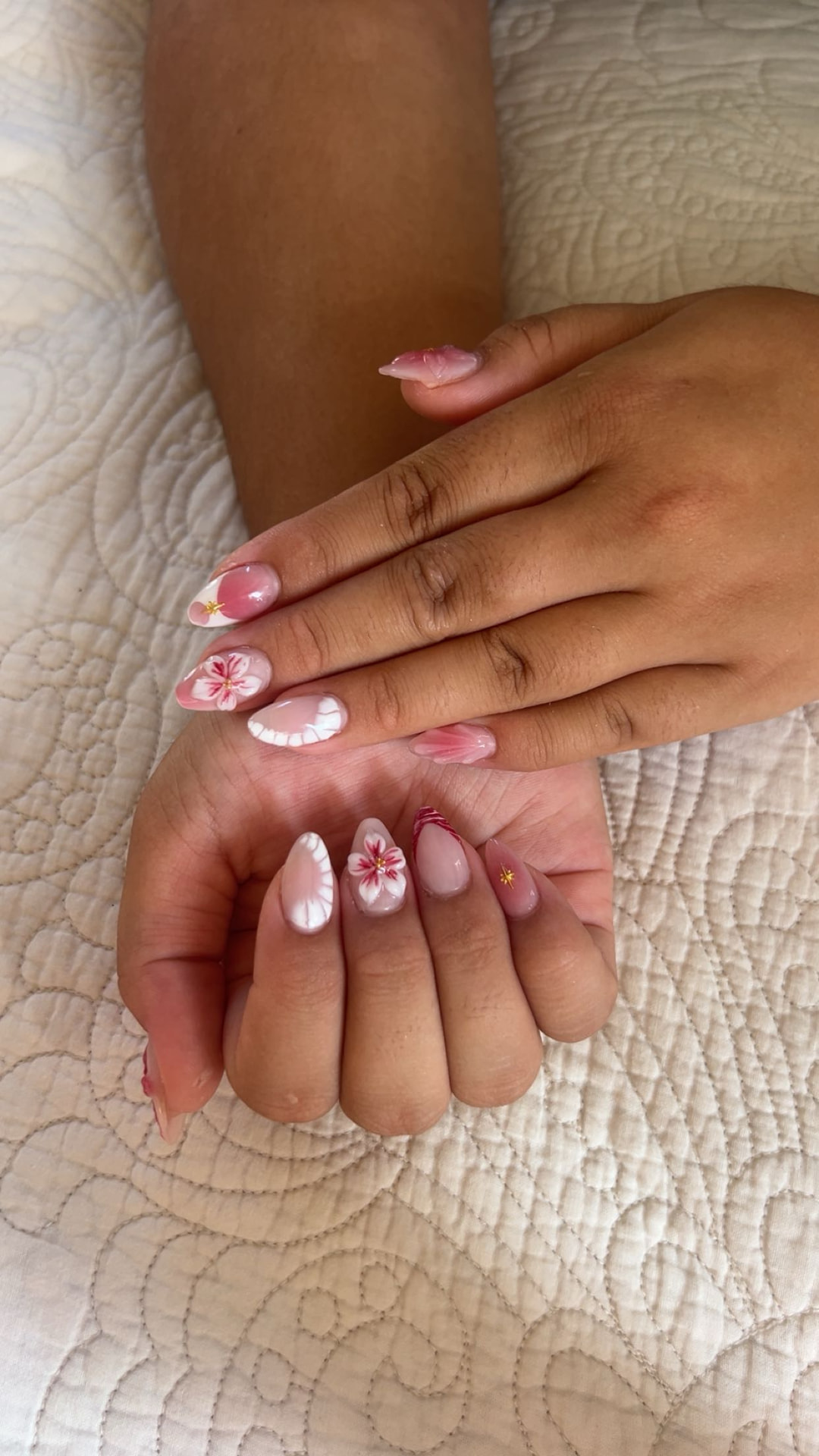 Pink and white almond nails with hand-painted hibiscus flowers by Kulia
